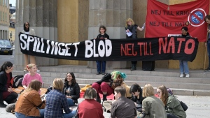Banners in Swedish proclaim 'Spilling Blood, No to NATO' during a protest outside the Swedish Parliament in Stockholm, on May 16, 2022. (Janerik Henriksson /TT News Agency via AP) 