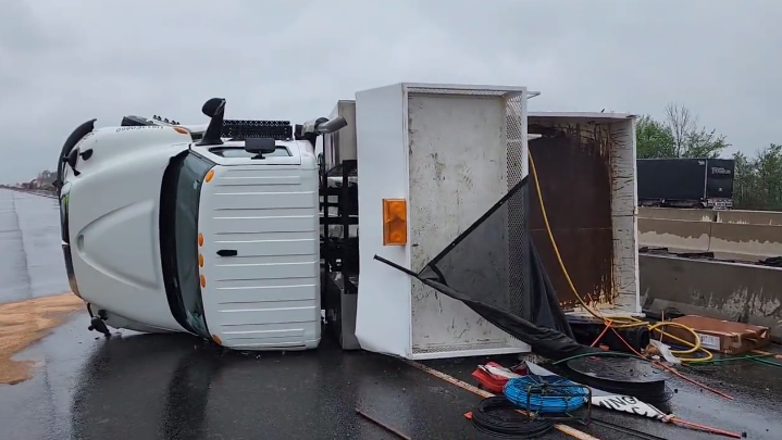A transport truck rolled onto its side in the northbound lanes of Highway 400 south of Newmarket, Ont., on Mon., May 16, 2022. (OPP Sgt. Kerry Schmidt/Twitter)