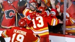 Calgary Flames forward Johnny Gaudreau (13) celebrates his goal with teammates during overtime NHL playoff hockey action against the Dallas Stars in Calgary, Alta., Sunday, May 15, 2022. (THE CANADIAN PRESS/Jeff McIntosh)