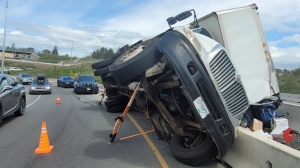 Traffic slowed but was still able to pass the stricken truck on the Admirals Road off-ramp around 1 p.m. (Saanich police/Twitter)