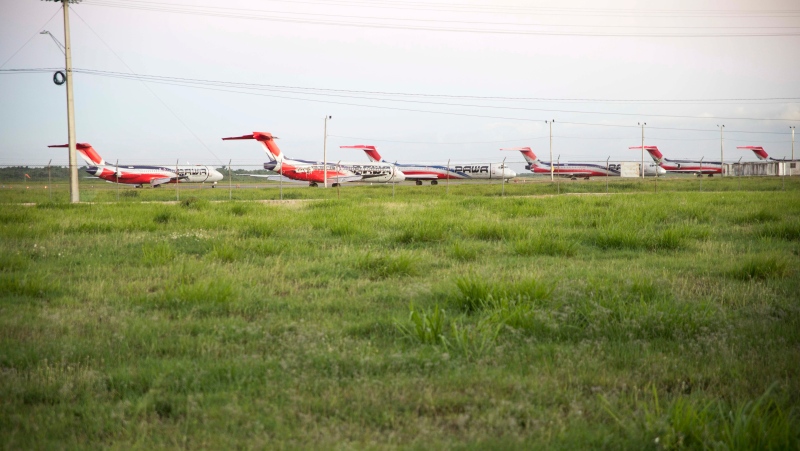 Grounded Pawa Dominicana airplanes are shown parked at Las Americas International Airport in Santo Domingo, Dominican Republic, Thursday, Feb. 1, 2017. (AP Photo/Tatiana Fernandez)