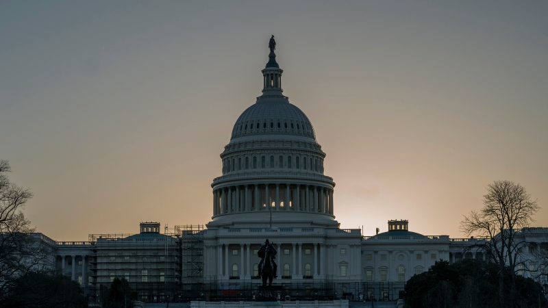 The U.S. Capitol building is seen as the sun rises in Washington, Monday, March 21, 2022. (AP Photo/Gemunu Amarasinghe)