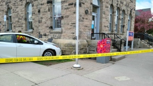 Police tape blocks off the scene where a car collided with the Elora post office. (Twitter/OPP West Region)