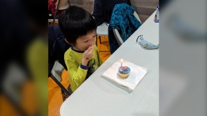 Six-year-old Max Chen eats a cupcake at his birthday party in Vancouver. Only one child from his class showed up even though everyone was invited. 
