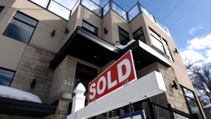 A for sale sign outside a home indicates that it has been sold, in Ottawa, on Monday, March 1, 2021. THE CANADIAN PRESS/Justin Tang 
