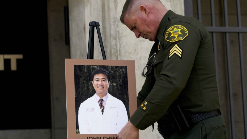 Orange County Sheriff's Sgt. Scott Steinle displays a photo of Dr. John Cheng, a 52-year-old victim who was killed in Sunday's shooting at Geneva Presbyterian Church, during a news conference in Santa Ana, Calif., Monday, May 16, 2022. (AP Photo/Jae C. Hong)