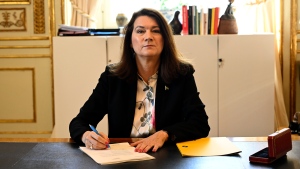 Swedish Minister of Foreign Affairs Ann Linde poses for photographers as she signs Sweden's application for NATO membership at the Ministry of Foreign Affairs, in Stockholm, May 17 2022. (Henrik Montgomery/TT News Agency via AP)