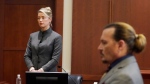 Actors Amber Heard and Johnny Depp watch as the jury leaves the courtroom at the end of the day at the Fairfax County Circuit Courthouse in Fairfax, Va., Monday, May 16, 2022. (AP Photo/Steve Helber, Pool)
