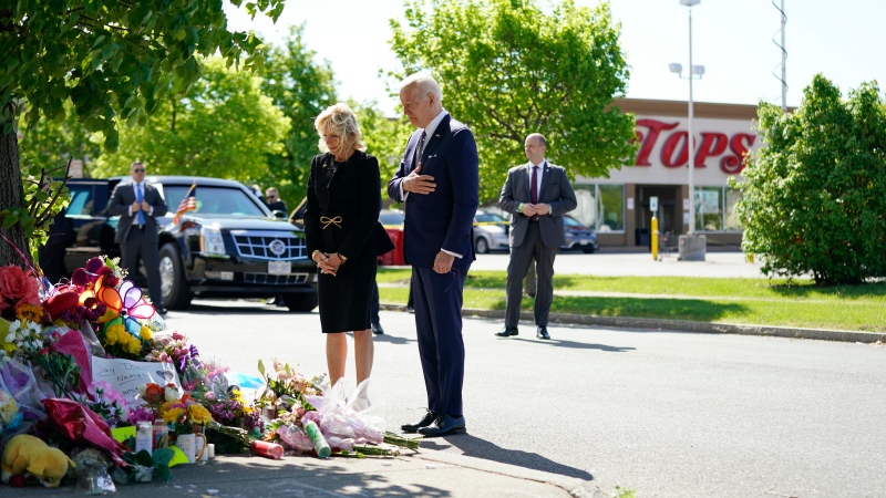 U.S. President Joe Biden and first lady Jill Biden visit the scene of a shooting at a supermarket to pay respects and speak to families of the victims of Saturday's shooting in Buffalo, N.Y., Tuesday, May 17, 2022. (AP Photo/Andrew Harnik)