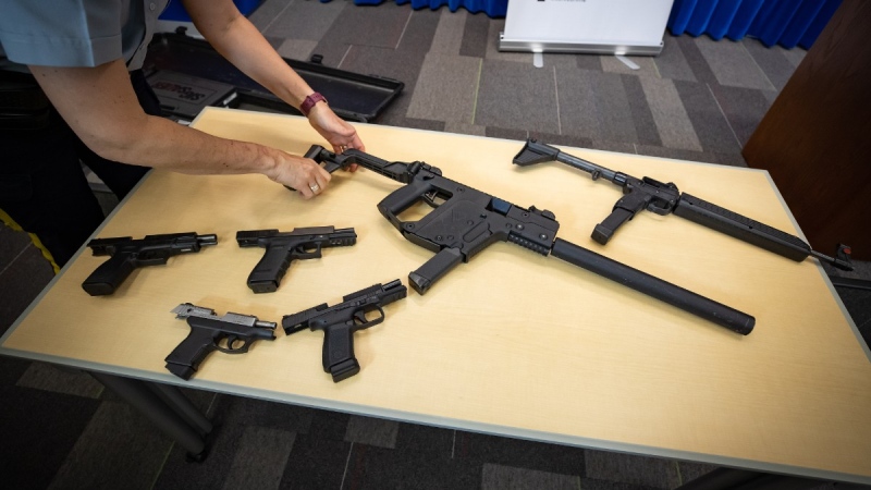 Seized firearms are displayed during an RCMP and Crime Stoppers news conference at RCMP headquarters in Surrey, B.C., on May 17, 2021. THE CANADIAN PRESS/Darryl Dyck