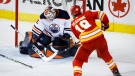 Edmonton Oilers goalie Mike Smith, left, lets in a goal from Calgary Flames' Matthew Tkachuk during second period NHL hockey action in Calgary, Saturday, March 26, 2022.THE CANADIAN PRESS/Jeff McIntosh