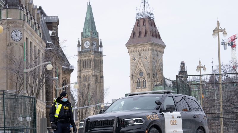 A police officer mans a checkpoint near Parliament Hill, Wednesday, Feb. 23, 2022 in Ottawa. THE CANADIAN PRESS/Adrian Wyld