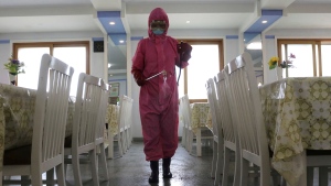 An employee of Pyongyang Dental Hygiene Products Factory disinfects the floor of a dining room as the state increased measures to stop the spread of illness in Pyongyang, North Korea on May 16, 2022.  (AP Photo/Cha Song Ho, File)
