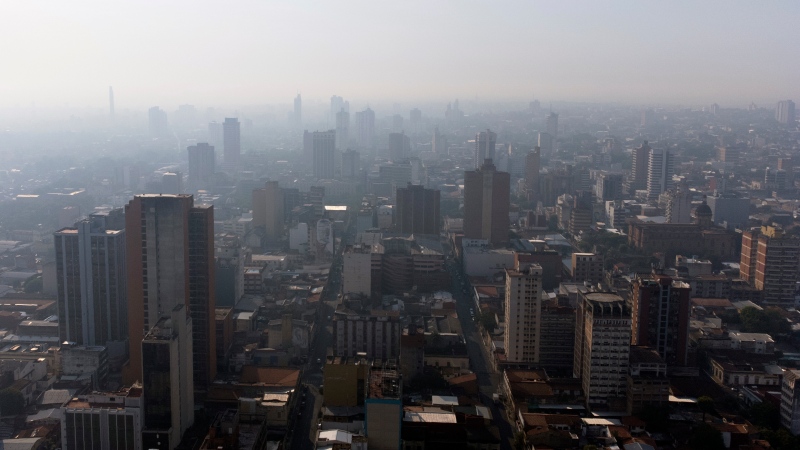 A dense haze of smoke hovers over Asuncion, Paraguay, Friday, Feb. 18, 2022, due to fires in the northern Argentina and southern Paraguay. (AP Photo/Jorge Saenz)