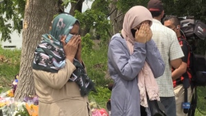 Women grieve at a memorial to the Afzaal family in June 2021. (CTV file photo)