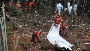 At the China Eastern flight crash site in Tengxian County in southern China's Guangxi Zhuang Autonomous Region on March 24, 2022.  (Lu Boan / Xinhua via AP) 