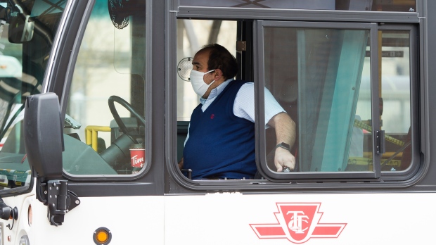 A TTC worker wears a mask in a bus while on shift in Toronto on Thursday, April 23, 2020. THE CANADIAN PRESS/Nathan Denette