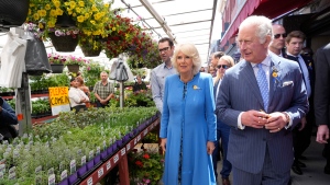 Prince Charles and Camilla, Duchess of Cornwall, check out plants for sale at the ByWard Market in Ottawa on their Canadian Royal Tour, Wednesday, May 18, 2022. (Paul Chiasson/THE CANADIAN PRESS)
