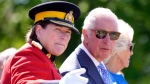 Prince Charles and Camilla, Duchess of Cornwall, talk with RCMP Commissioner Brenda Lucki as they watch a performance of the RCMP Musical Ride, in Ottawa on their Canadian Royal Tour, Wednesday, May 18, 2022. THE CANADIAN PRESS/Paul Chiasson