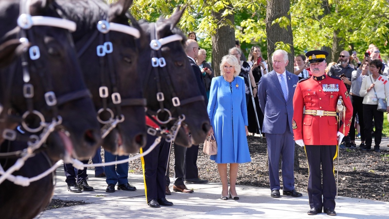 Prince Charles and Camilla, Duchess of Cornwall, inspect members of the RCMP Musical Ride, in Ottawa on their Canadian Royal Tour, Wednesday, May 18, 2022. (Paul Chiasson/THE CANADIAN PRESS)