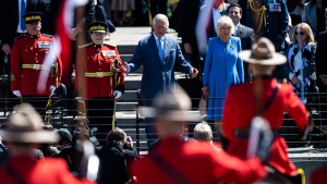 Prince Charles motions for the performance of the RCMP Musical Ride to begin, as he attends with Camilla, Duchess of Cornwall and RCMP Commissioner Brenda Lucki, second from left, in Ottawa, during their Canadian Royal tour, on Wednesday, May 18, 2022. (Justin Tang/THE CANADIAN PRESS) 