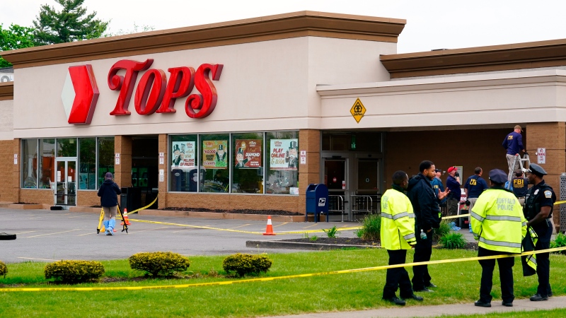 Investigators work the scene of a shooting at a supermarket, in Buffalo, N.Y., Monday, May 16, 2022. (AP Photo/Matt Rourke)