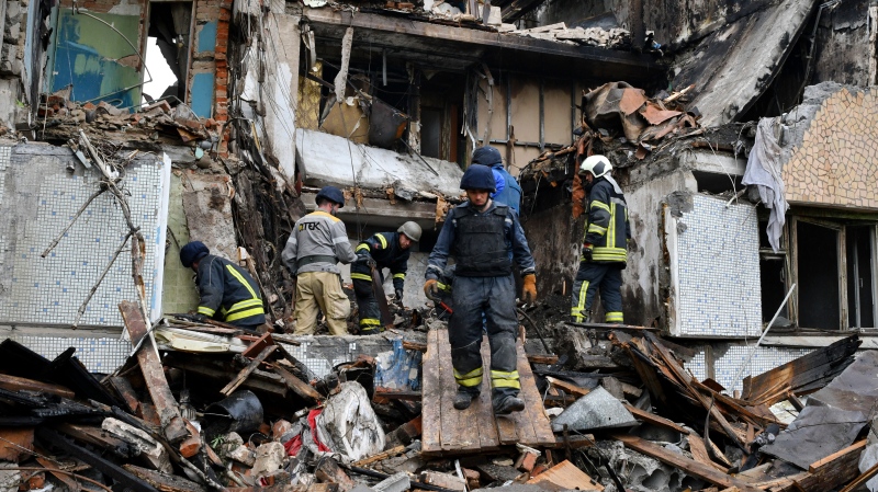 Rescuers work at a site of an apartment building destroyed by Russian shelling in Bakhmut, Donetsk region, Ukraine, May 18, 2022. (AP Photo/Andriy Andriyenko)