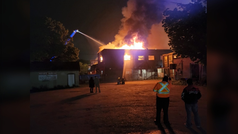 Firefighters battle a glaze at Fabulous Fashions and the former Forum Hotel Rooming House in Hanover, Ont. on May 18, 2022. (Source: Hanover police)