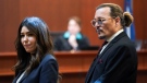 Johnny Depp stands next to his lawyer, Camille Vasquez, after a break in the courtroom at the Fairfax County Circuit Courthouse in Fairfax, Va., on May 18, 2022. (Kevin Lamarque / Pool Photo via AP)