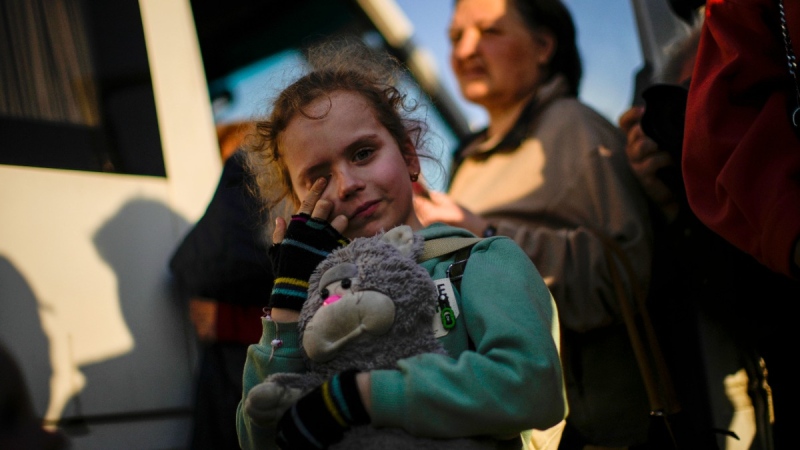 A child and her family who fled from Mariupol arrive in Zaporizhzhia, Ukraine, on May 8, 2022. (Francisco Seco / AP) 