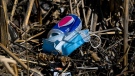 A used mask lays in the ditch along with other littered garbage during the COVID-19 pandemic in Brampton, Ont., on Monday, March 15, 2021. THE CANADIAN PRESS/Nathan Denette