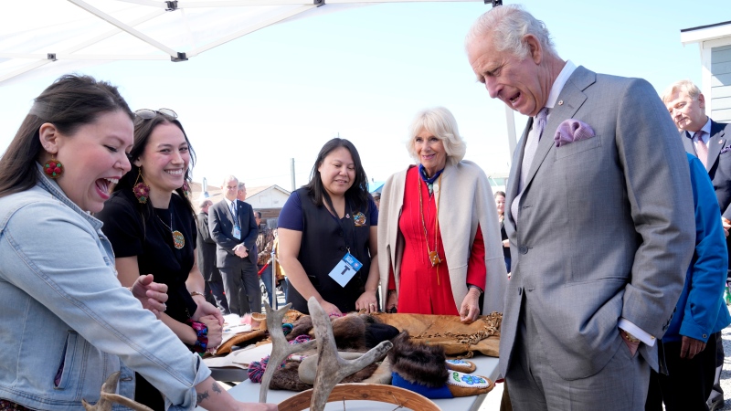 Prince Charles, right, and Camilla, Duchess of Cornwall, second from right, look at a display of traditional hunting tools and clothing after arriving in Yellowknife, Northwest Territories, during part of the Royal Tour of Canada, Thursday, May 19, 2022. THE CANADIAN PRESS/Paul Chiasson
