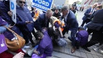 Police remove protesters who were blocking PC Leader Doug Ford’s arrival outside the Ontario election leaders’ debate in Toronto on Monday, May 16, 2022. THE CANADIAN PRESS/Frank Gunn 