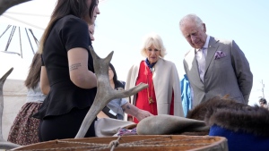 Prince Charles, right, and Camilla, Duchess of Cornwall, second from right, look at a display of traditional hunting tools and clothing after arriving in Yellowknife, Northwest Territories, during their tour of Canada, May 19, 2022. THE CANADIAN PRESS/Paul Chiasson