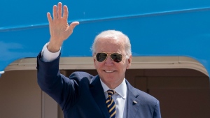 U.S. President Joe Biden waves as he boards Air Force One for a trip to South Korea and Japan, on May 19, 2022. (Gemunu Amarasinghe / AP) 