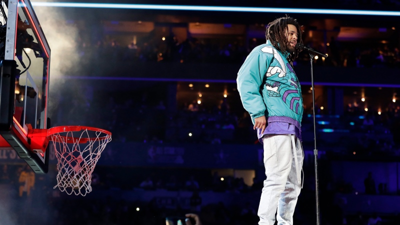 Rapper J. Cole performs at halftime during NBA All-Star basketball game, Sunday, Feb. 17, 2019, in Charlotte, N.C. (AP Photo/Chuck Burton)