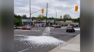 An unidentified foamy substance is seen spewing from the roadway at the intersection of King Street and Fountain Street. (Facebook/Patricia Thomas)