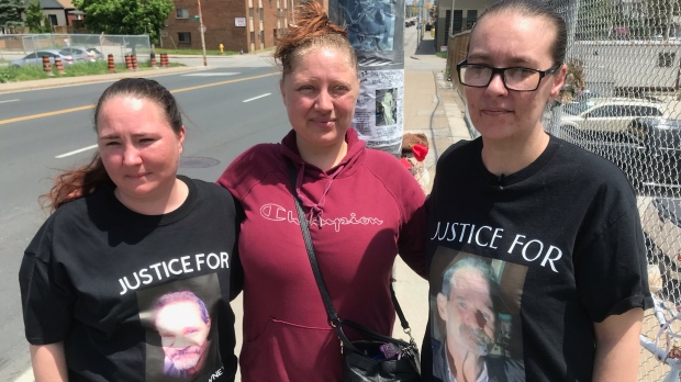 The family of Ken McEldowney stands near the memorial they placed on Wyandotte Street West in Windsor, Ont. on Friday, May 20, 2022 (Michelle Maluske/CTV News Windsor)