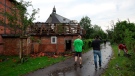 People stand in front of a damaged house after a suspected tornado in Lippstadt, Germany, Friday, May 20, 2022. (Friso Gentsch/dpa via AP)