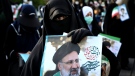 A supporter of presidential candidate Ebrahim Raisi holds a sign during a rally in Tehran, Iran, Wednesday, June 16, 2021.(AP Photo/Ebrahim Noroozi)
