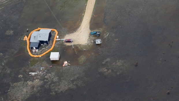 A home on Peguis First Nation with a Tiger Dam around it for Fisher River flooding north of Winnipeg, Sunday, May 15, 2022. Residents of the community were evacuated. The river levels have dropped considerably this week. THE CANADIAN PRESS/John Woods/POOL