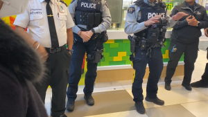 Surrey RCMP officers are seen outside a busy Service Canada office on Friday, May 20, 2022. 