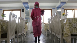 FILE - An employee of Pyongyang Dental Hygiene Products Factory disinfects the floor of a dining room as the state increased measures to stop the spread of illness in Pyongyang, North Korea on May 16, 2022. (AP Photo/Cha Song Ho, File)