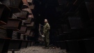 In this photo provided by Azov Special Forces Regiment of the Ukrainian National Guard Press Office, a Ukrainian soldier stands inside the ruined Azovstal steel plant prior to surrender to the Russian forces in Mariupol, Ukraine, May 19, 2022. (Dmytro Kozatski/Azov Special Forces Regiment of the Ukrainian National Guard Press Office via AP)