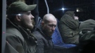 Ukrainian servicemen sit in a bus after leaving Mariupol's besieged Azovstal steel plant, near a penal colony, in Olyonivka, in territory under the government of the Donetsk People's Republic, eastern Ukraine, May 20, 2022. (AP Photo)