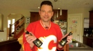 Life-long Calgary Flames fan Shane Byciuk with two bottles of Champagne he sneaked into the Saddledome in 2004 during the Stanley Cup playoffs.