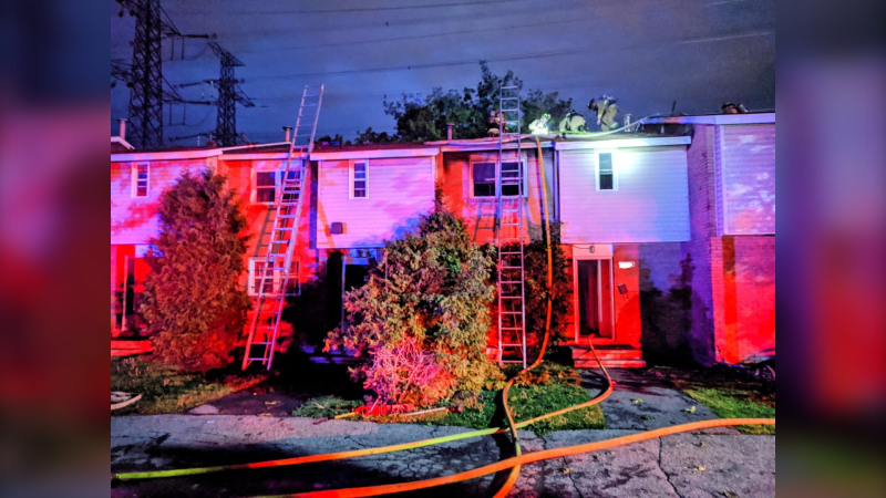 Ottawa fire responded to a fire in the second floor bedroom of a row house on Ledbury Avenue Saturday night. (Ottawa Fire photographer Scott Stilborn/Twitter)