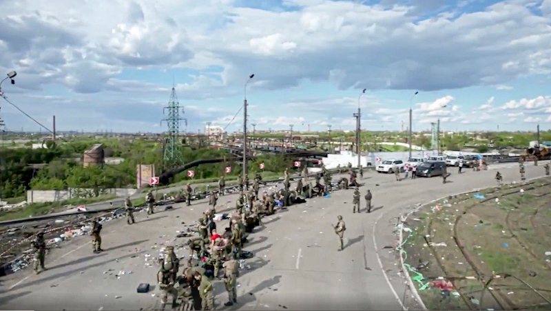 In this photo taken from video released by the Russian Defence Ministry on Saturday, May 21, 2022, Ukrainian servicemen line up to be checked as they leave the besieged Azovstal steel plant in Mariupol, in territory under the government of the Donetsk People's Republic, eastern Ukraine. (Russian Defense Ministry Press Service via AP)