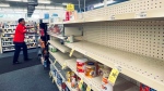 FILE - An employee walks near empty shelves where baby formula would normally be located at a CVS in New Orleans on Monday, May 16, 2022. (Chris Granger/The Times-Picayune/The New Orleans Advocate via AP)