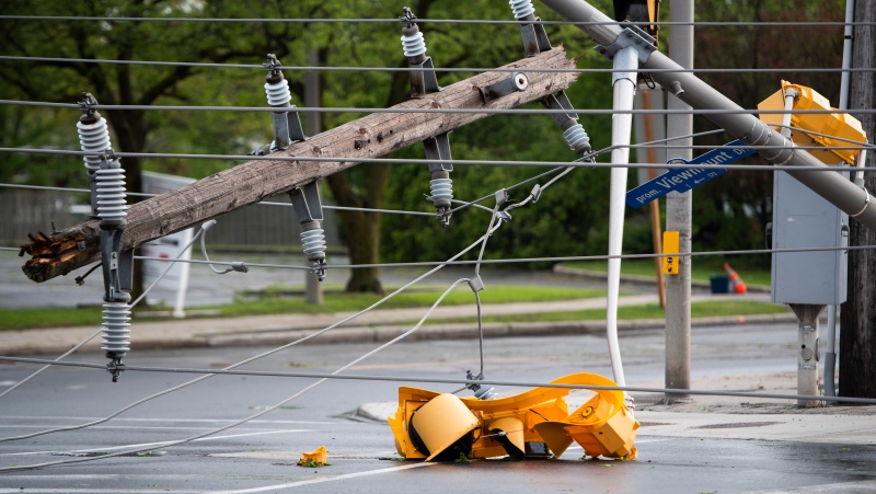 A traffic light and segment of a utility pole are seen in the intersection of Viewmount Drive and Merivale Road after a major storm took down power lines and utility poles, blocking in multiple vehicles, on Merivale Road in Ottawa, on Saturday, May 21, 2022. (Justin Tang/THE CANADIAN PRESS)